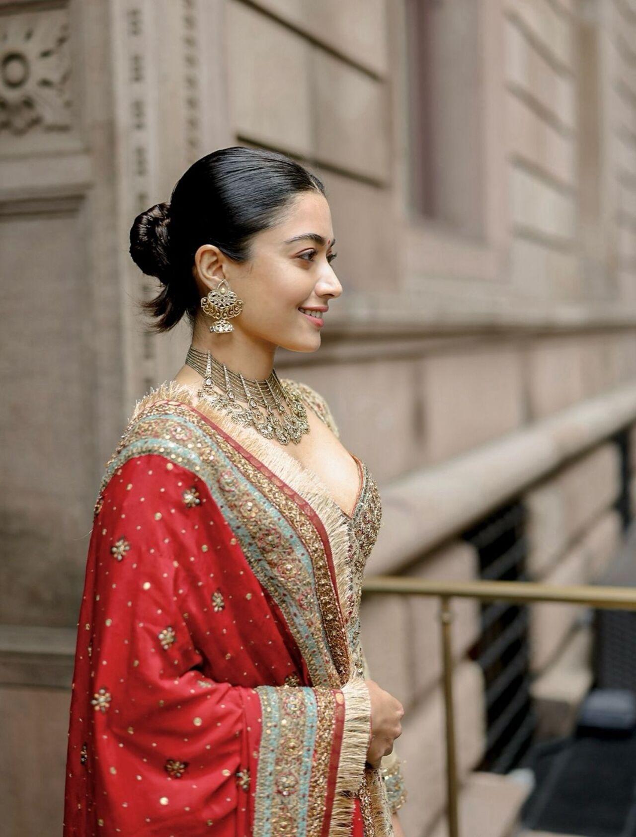 Rashmika keeps it romantic with an updo that allows soft hair to fall naturally. This style is effortlessly pretty and ideal for intimate festive gatherings.